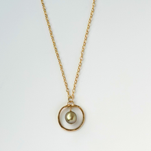 Load image into Gallery viewer, image of gold filled necklace with round pendant featuring a green pearl in the middle
